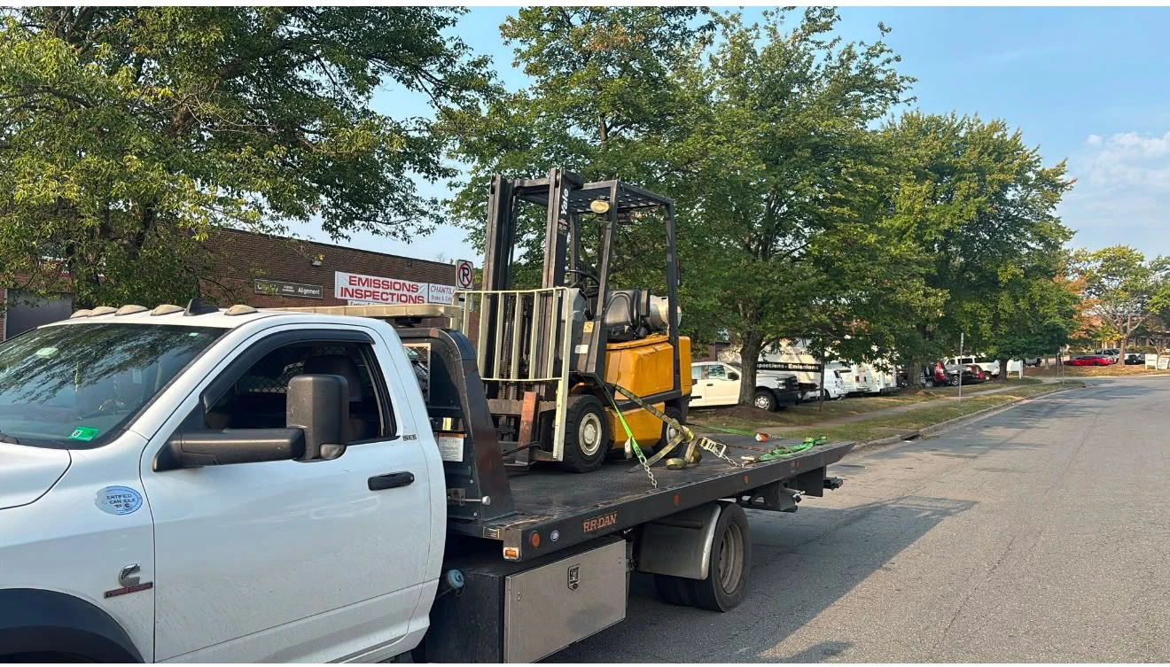 V&S Towing flatbed transporting a forklift in Fairfax VA